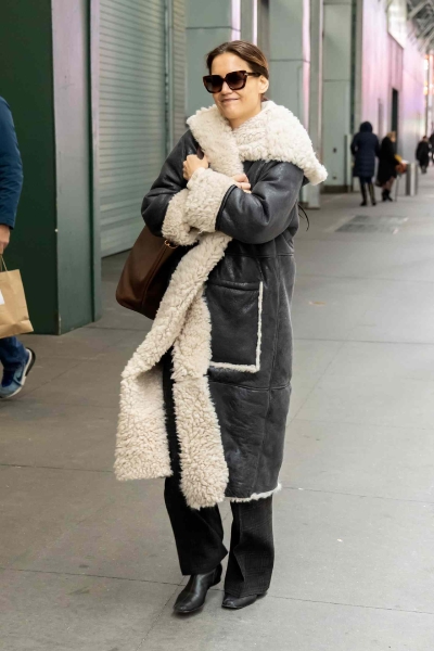 Suri Cruise was spotted in an outfit that looked like it came directly from Katie Holmes's closet. Cruise wore baggy jeans and a puffer jacket to see her mom's production of 'Our Town' on Broadway.