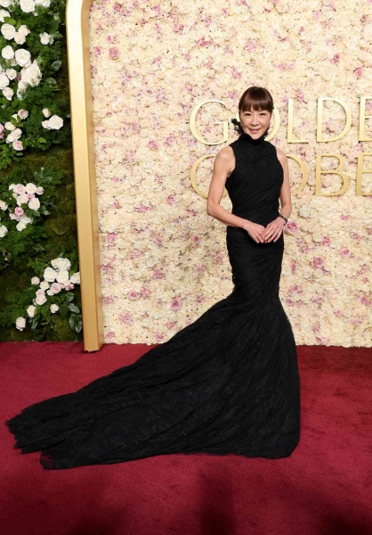 Michelle Yeoh presented at the 2025 Golden Globe Awards and wore a gown by Balenciaga and a fresh set of bangs. See Yeoh's 2025 Golden Globes red carpet and presenting outfits here.