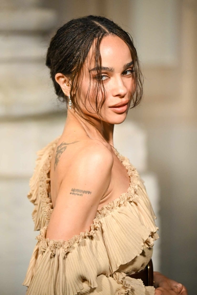 Zoë Kravitz looked ready for spring as she debuted new caramel highlights and unexpected rainbow-colored strappy sandals as she stepped out at Paris Fashion Week for the Saint Laurent Menswear Fall-Winter 2025/2026 show on January 28. See the whimsical look, here.