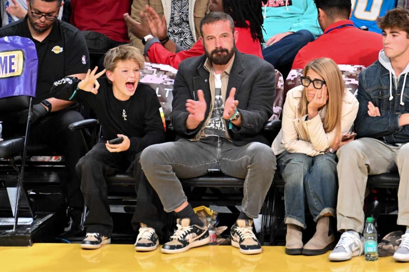 Ben Affleck and his lookalike youngest son Samuel had a matching style moment as they showed off similar versions of the same ultra-rare footwear at the February 6 Lakers and Warriors basketball game. See their complementary father-son looks, here.