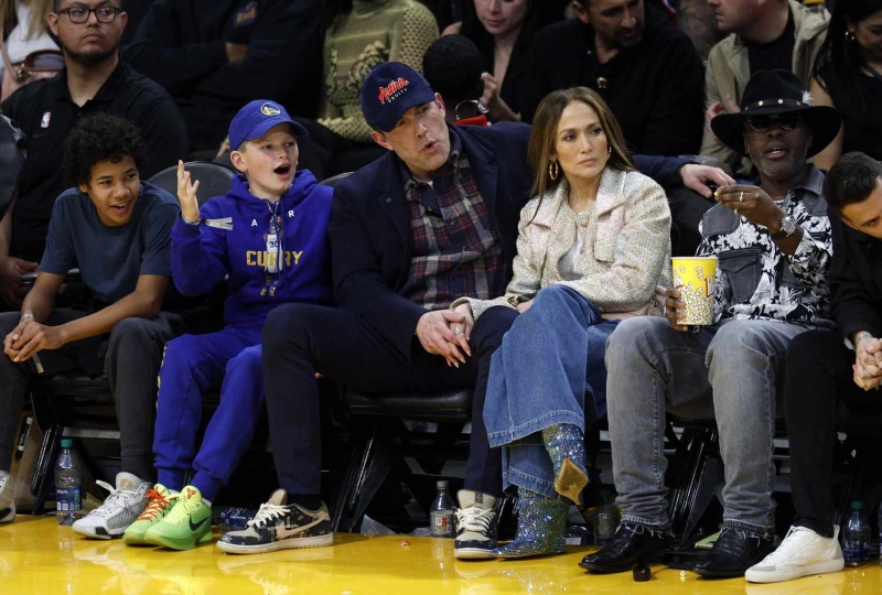 Ben Affleck and his lookalike youngest son Samuel had a matching style moment as they showed off similar versions of the same ultra-rare footwear at the February 6 Lakers and Warriors basketball game. See their complementary father-son looks, here.