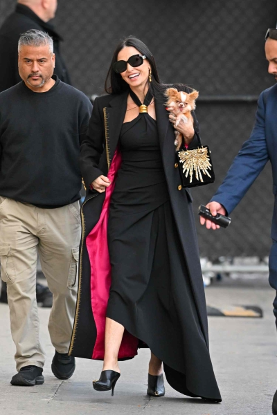 Demi Moore wore a gold-and-black Schiaparelli dress while carrying her iconic dog Pilaf on her way to Jimmy Kimmel.