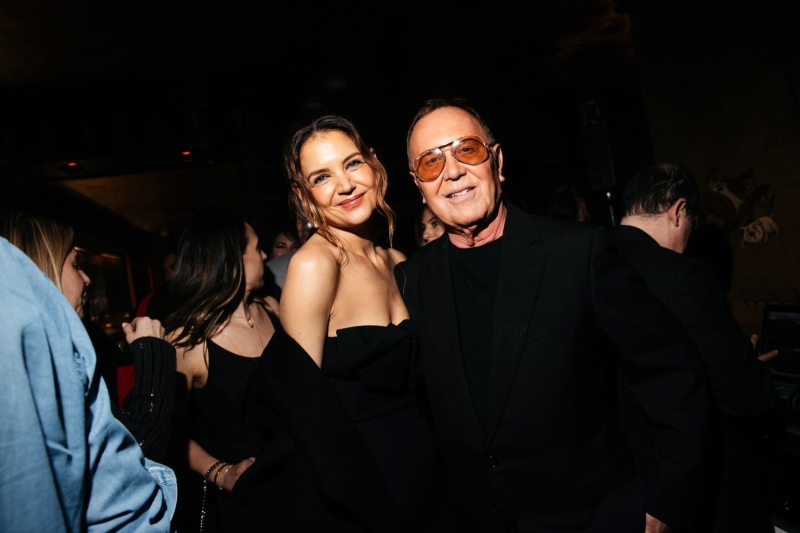 Katie Holmes attended a cocktail party at Bemelmans Bar in New York City wearing a strapless little black dress paired with a black coat and statement earrings.