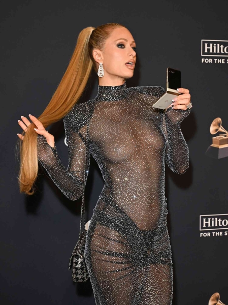 Paris Hilton wore her most naked dress yet as she went braless in a sheer LBD at Clive Davis's pre-Grammys party on Saturday, February 1. See her barely-there look, here.