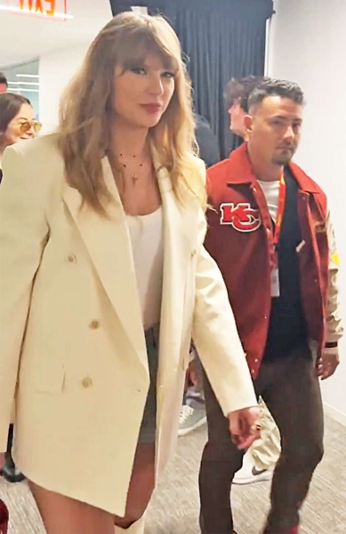 Taylor Swift's white outfit at the 2025 Super Bowl LIX was filled with plenty of fashion Easter eggs—including the "T" for Travis Kelce chain she wore to the Grammys.